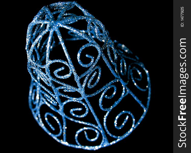 Blue and sprakly christmas bell ornament on a black background