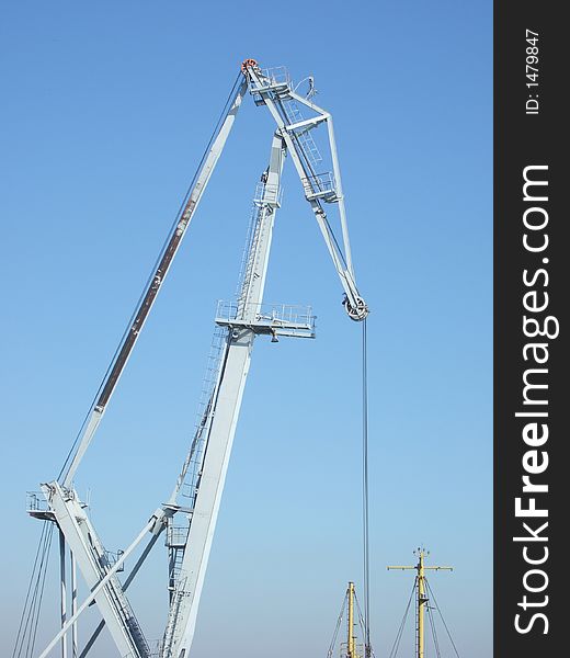 Photo of a loading crane on sky background