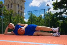 Young Man With Basketball Ball Relaxes Stock Images Young Man With Basketball Ball Relaxes Stock Images
