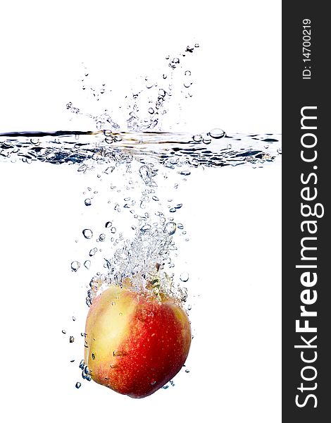 Red apple splashing into water isolated on white background. Red apple splashing into water isolated on white background