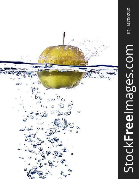 Green apple splashing into water isolated on white background. Green apple splashing into water isolated on white background