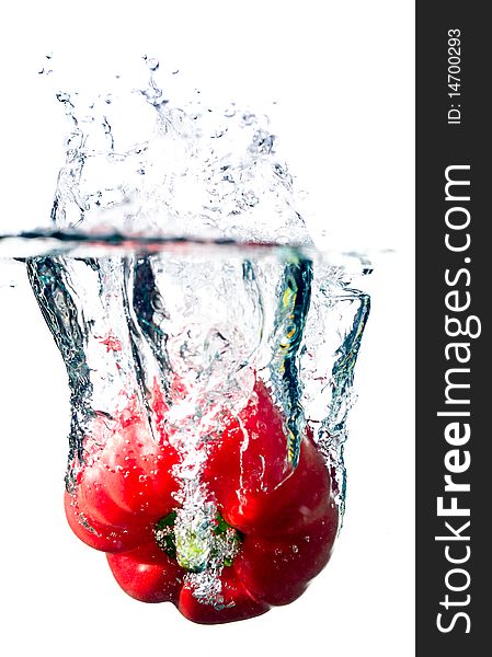 Water splash on red pepper isolated on white. Water splash on red pepper isolated on white