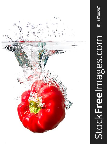 Water splash on red pepper isolated on white. Water splash on red pepper isolated on white