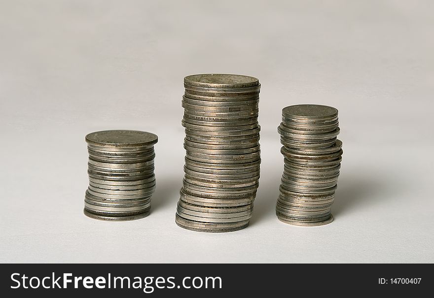 Three columns of the coins on white background