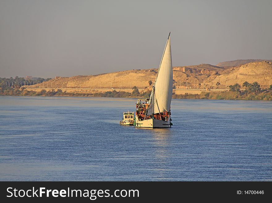 Sailing ship with a small motor boat on the Nile in Egypt