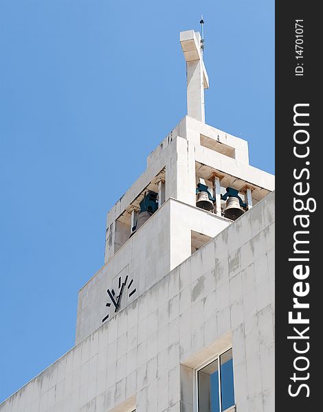 Ground view of a church tower, bells and clock. Ground view of a church tower, bells and clock