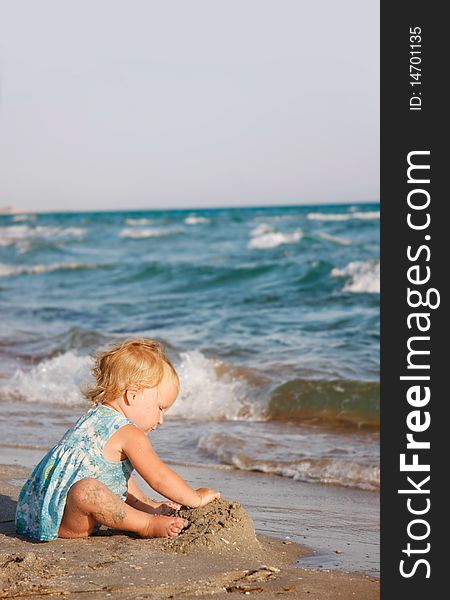 Toddler girl playing on beach