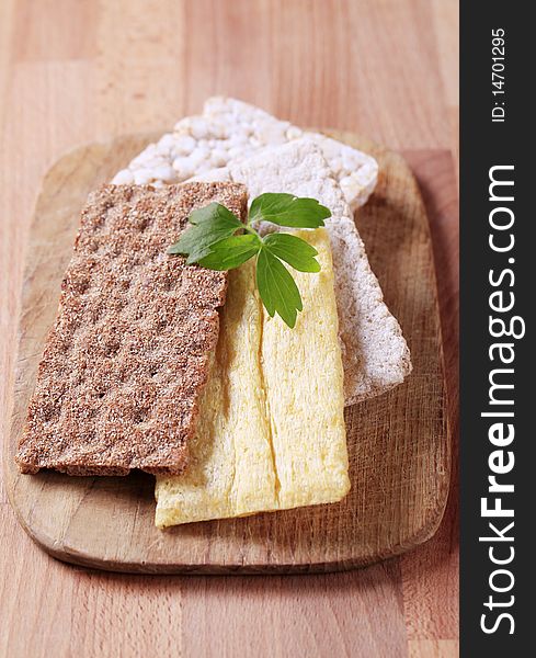 Various kinds of crispbread on a cutting board. Various kinds of crispbread on a cutting board