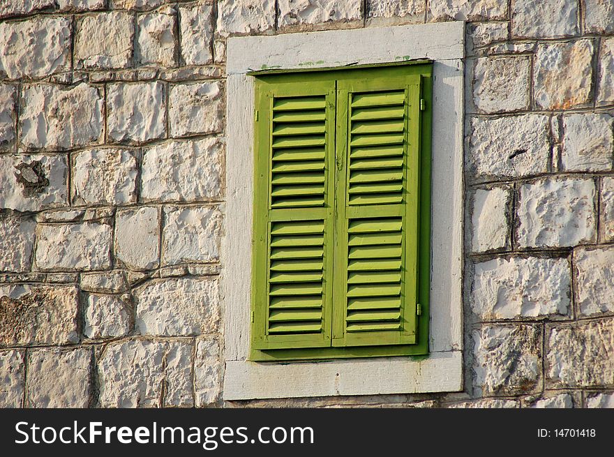 A window closed with green shutters
