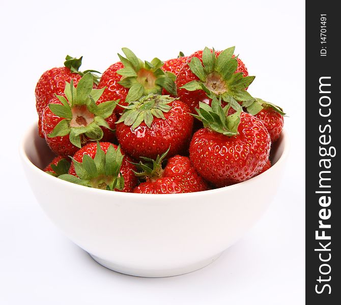 Strawberries in a bowl on white background