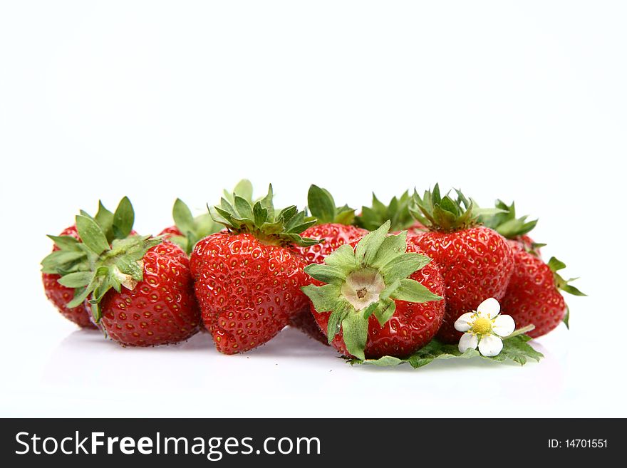 Strawberries with a leaf and a flower on white background