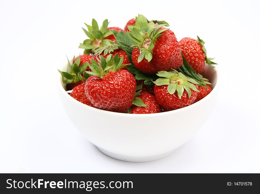 Strawberries in a bowl on white background