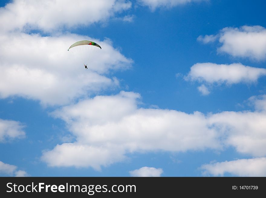 Paraglider flying over the field
