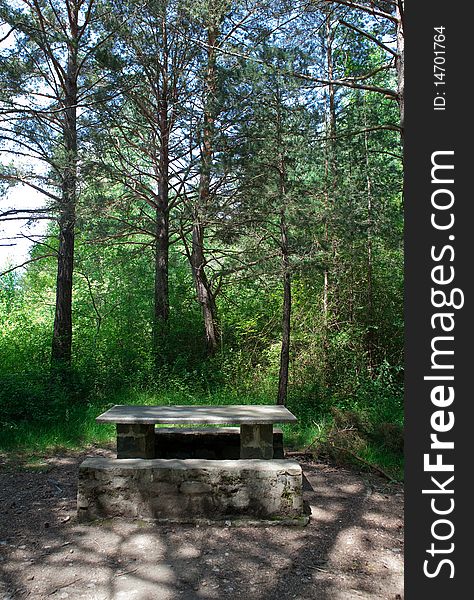 Picnic table among the trees of the forest. Picnic table among the trees of the forest