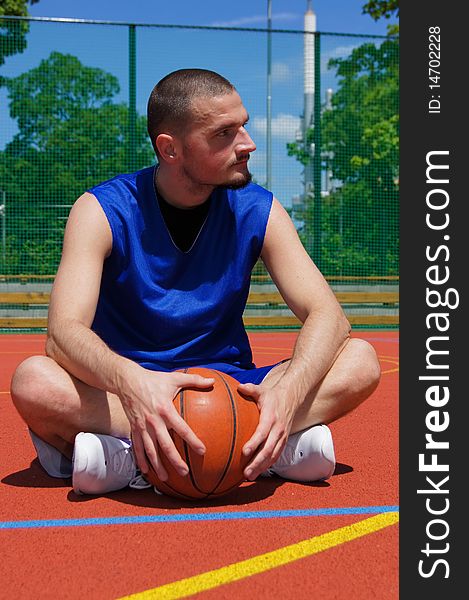 Young basketball player with basketball ball on the sportground with look left. Young basketball player with basketball ball on the sportground with look left