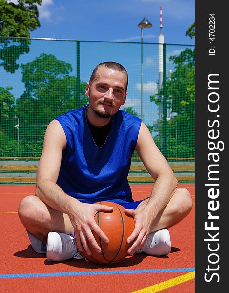 Young basketball player with basketball ball on the sportground. Young basketball player with basketball ball on the sportground