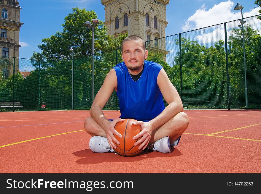 Young basketball player with ball on the sportground - wide picture. Young basketball player with ball on the sportground - wide picture