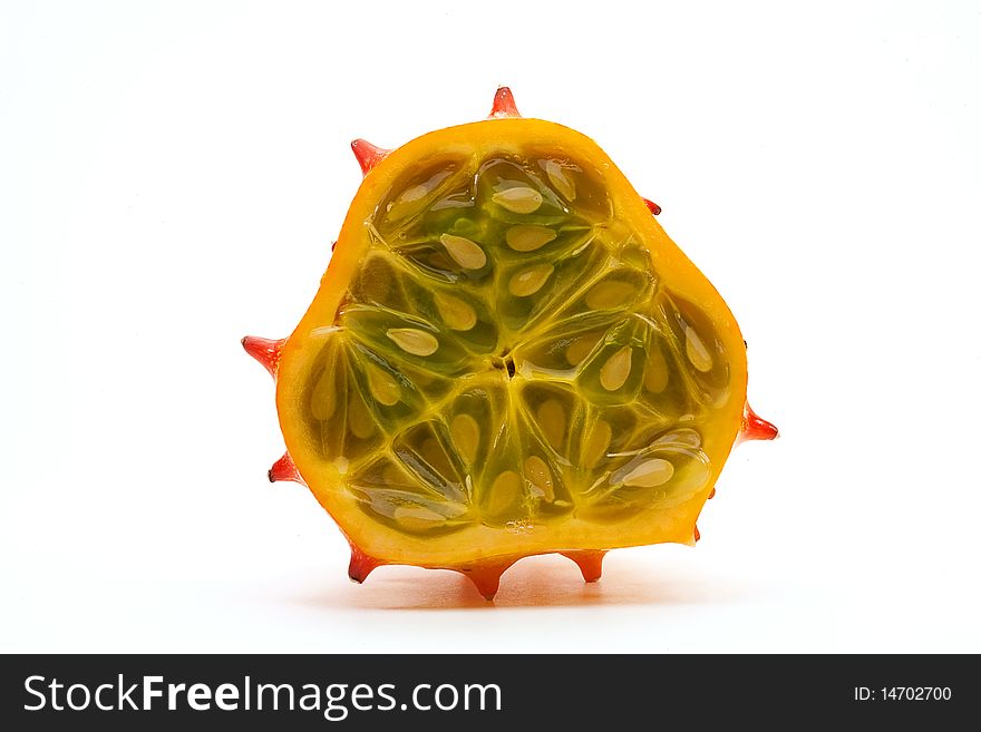 Horned melon, also known as Blowfish Fruit, cut away showing inside seeds and pulp on a white background. Horned melon, also known as Blowfish Fruit, cut away showing inside seeds and pulp on a white background.