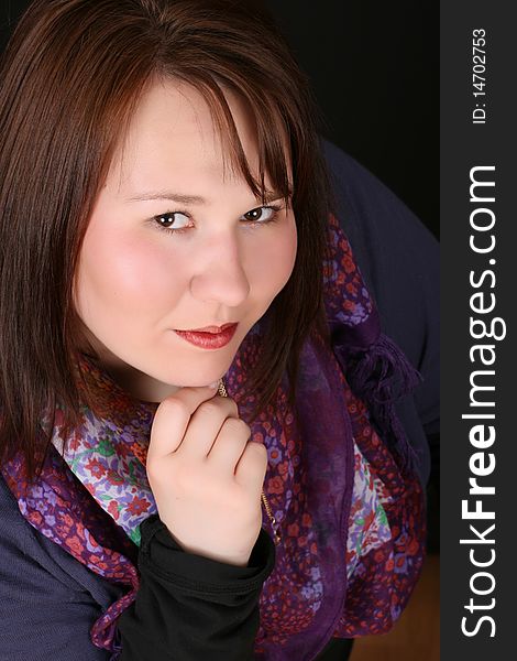 Headshot of beautiful brunette female on a black background