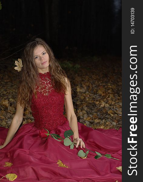 Girl in a red dress with a maple leaf in her hair. Girl in a red dress with a maple leaf in her hair