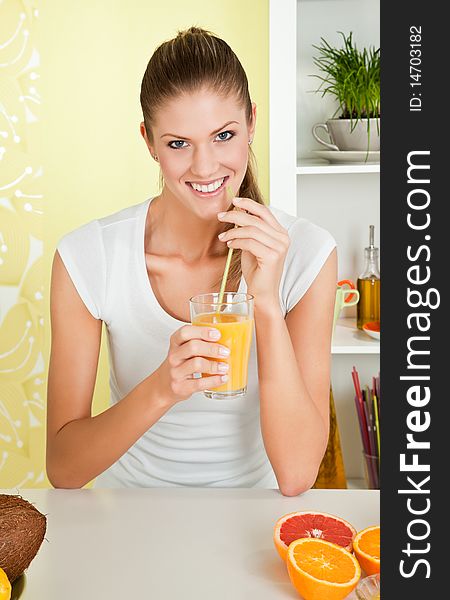 Young beauty woman drinking a glass of orange juice. Young beauty woman drinking a glass of orange juice