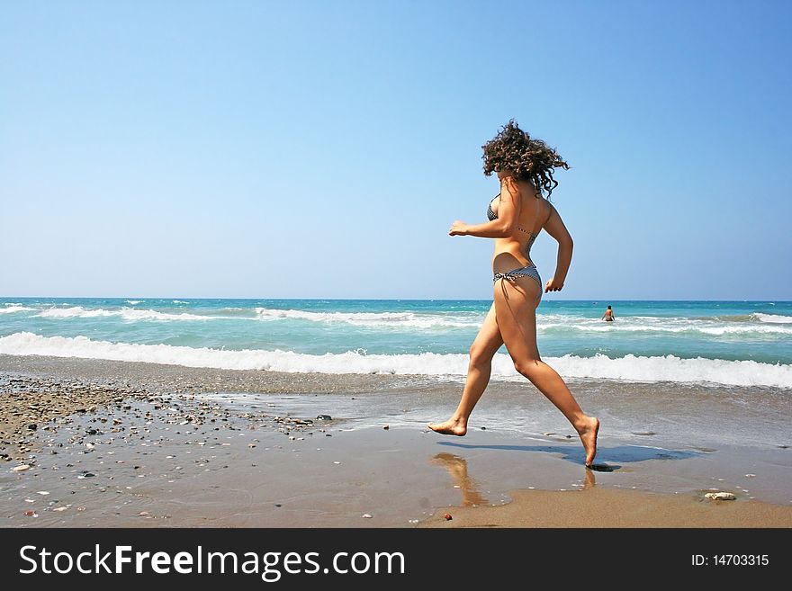 Running girl on the beach.