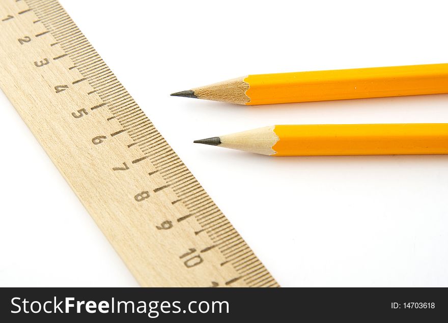 Ruler and two pencils isolated on white background