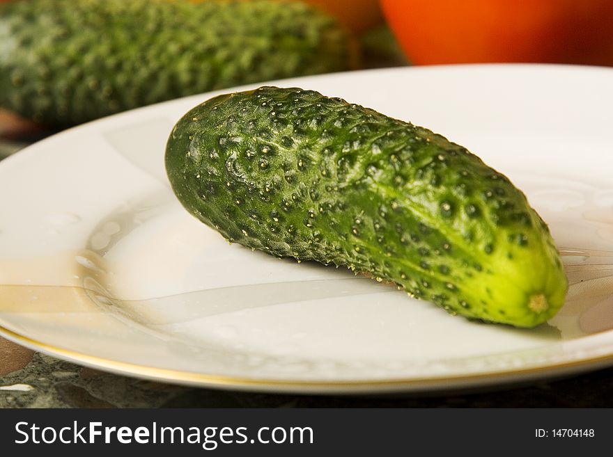 Fresh green cucumber on a plate