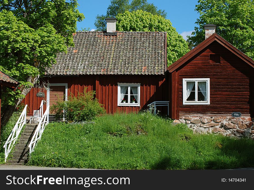 Two old loghouses in the swedish summer