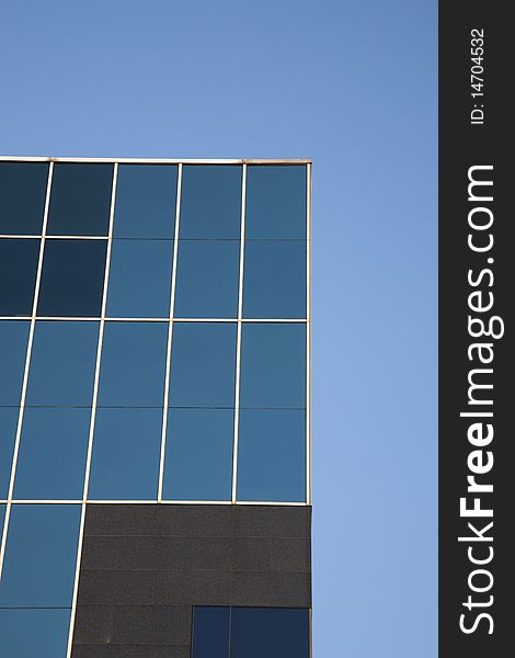 Blue Modern Office window facade against blue sky background. Blue Modern Office window facade against blue sky background