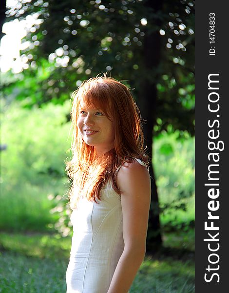 Redhead girl smiles on a summer evening. Redhead girl smiles on a summer evening