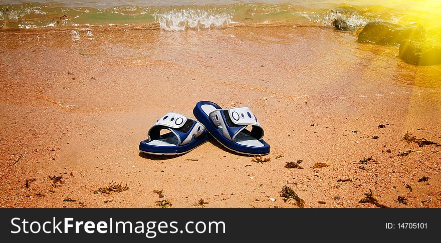 Wet Sandals Next To The Sea.