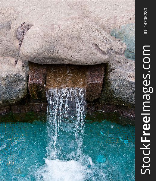 Pure water falling out thru the man-made gutter. Pure water falling out thru the man-made gutter