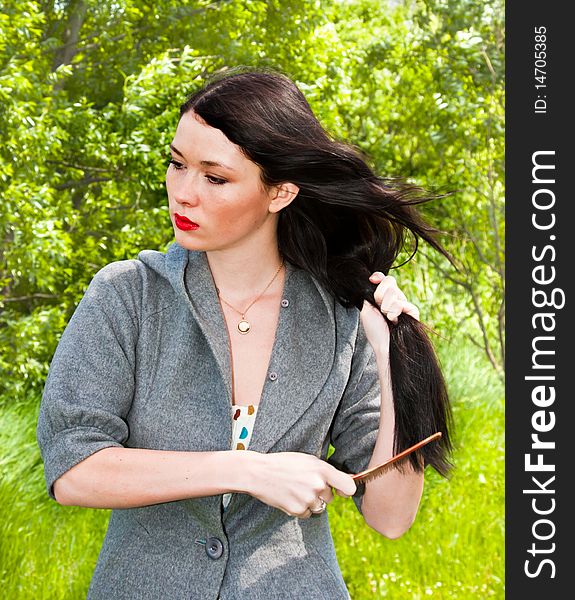 Young cute smiling women in the park with green grass background