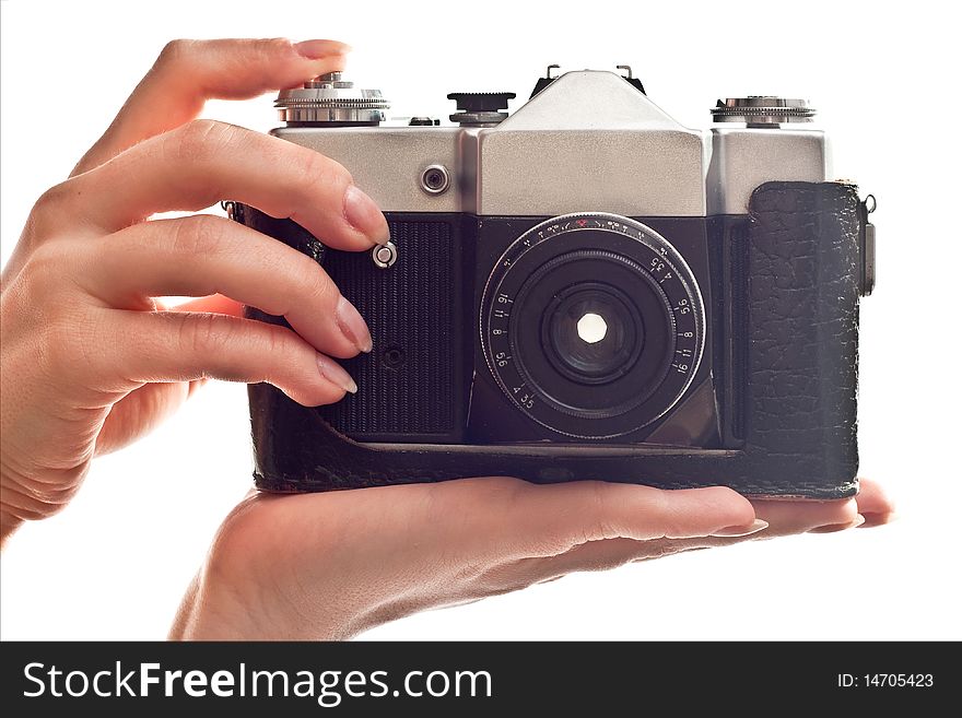 Black old camera in woman's hand. Isolated on white