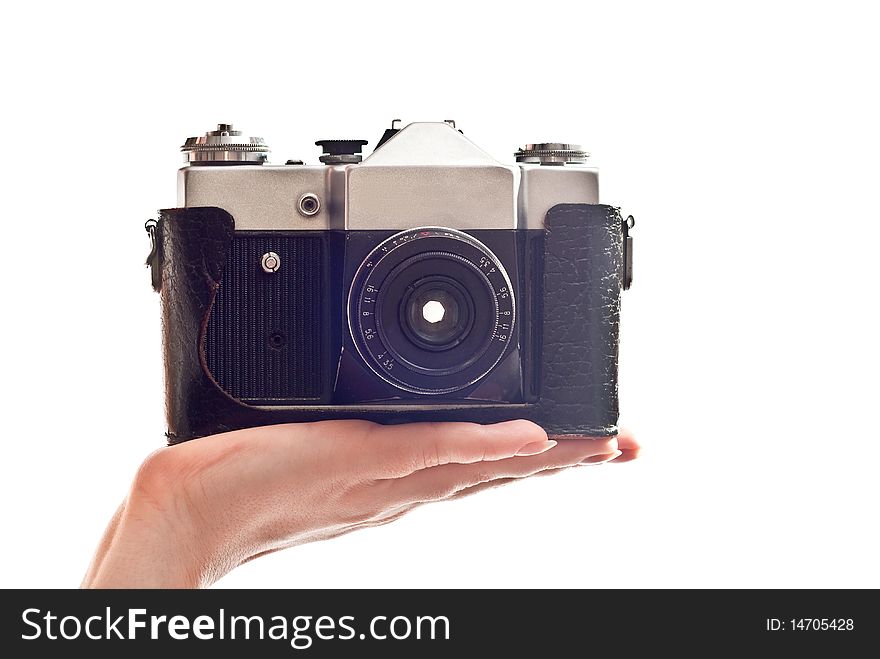 Black old camera in woman's hand. Isolated on white background