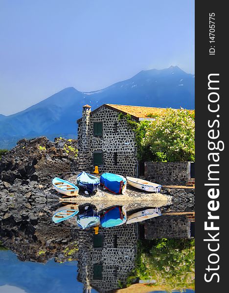 Photo of house on the lake, fishing boats and mountains. Photo of house on the lake, fishing boats and mountains