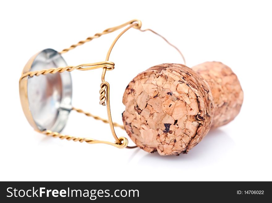 Macro view of champagne cork with gold colored wire, isolated on white background.