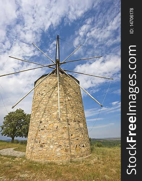 Traditional built with stones windmill in Greece. Traditional built with stones windmill in Greece