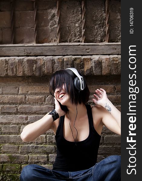 Young beautiful urban girl enjoying music. Young beautiful urban girl enjoying music