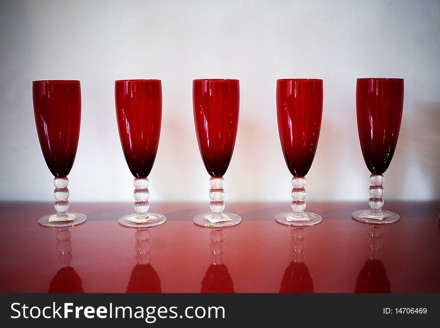 Red glass cups stand on the table. Red glass cups stand on the table