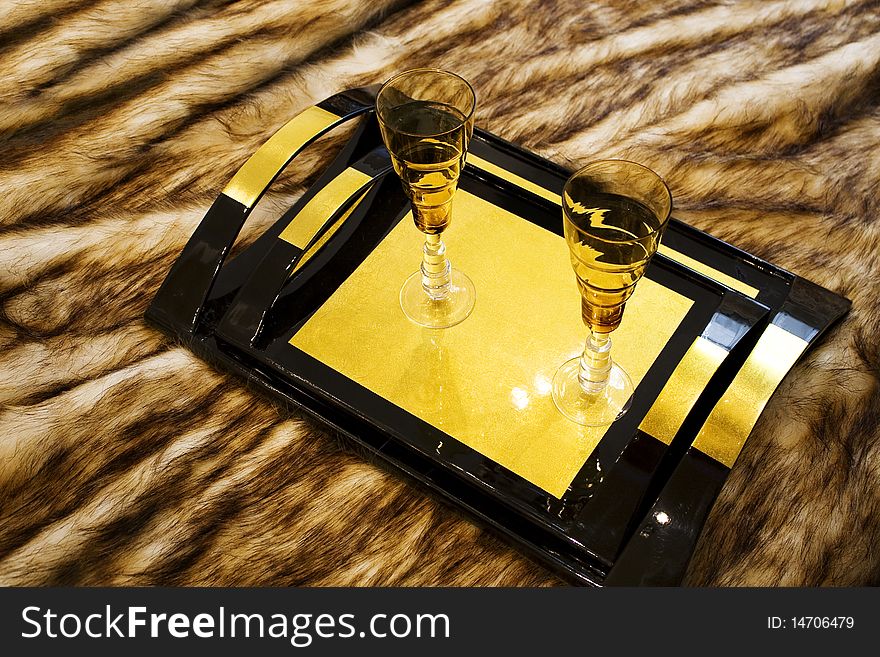 Yellow glass cups stand on the carpet. Yellow glass cups stand on the carpet