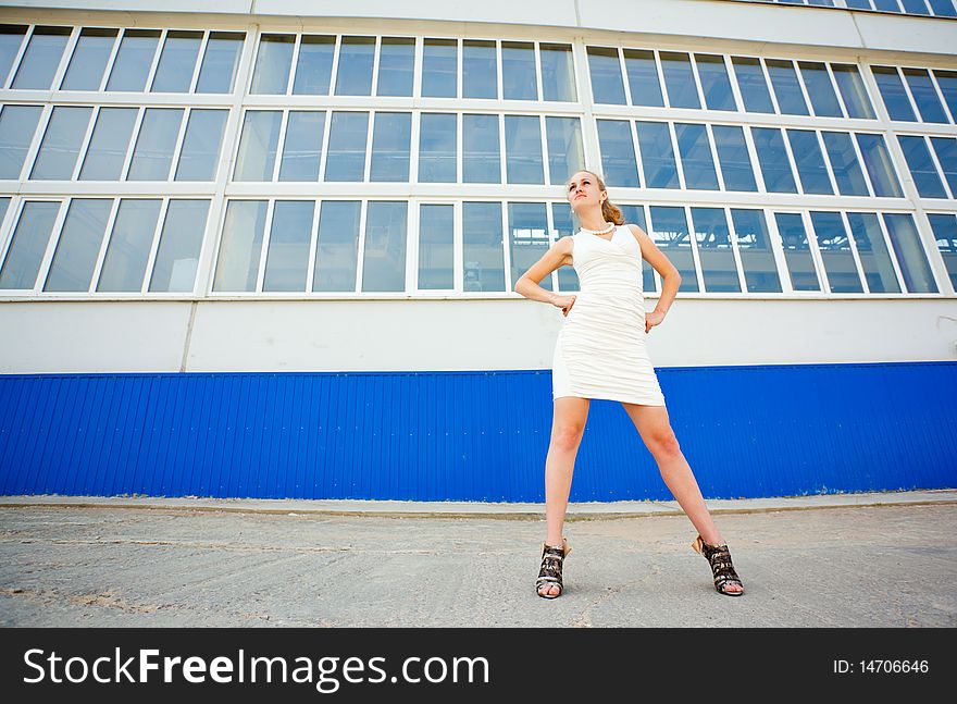 Young girl posing over old factory. Young girl posing over old factory