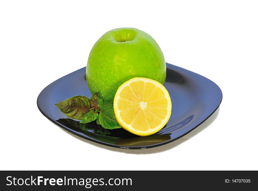 Iisolated green apple and yellow lemon on a plate 2. Iisolated green apple and yellow lemon on a plate 2