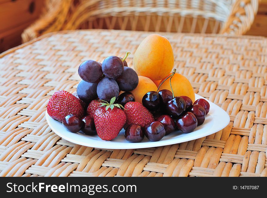 Plate with fruit and berries on the table