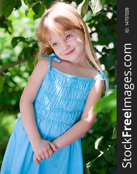 Little Girl In The Park Wearing Blue Dress