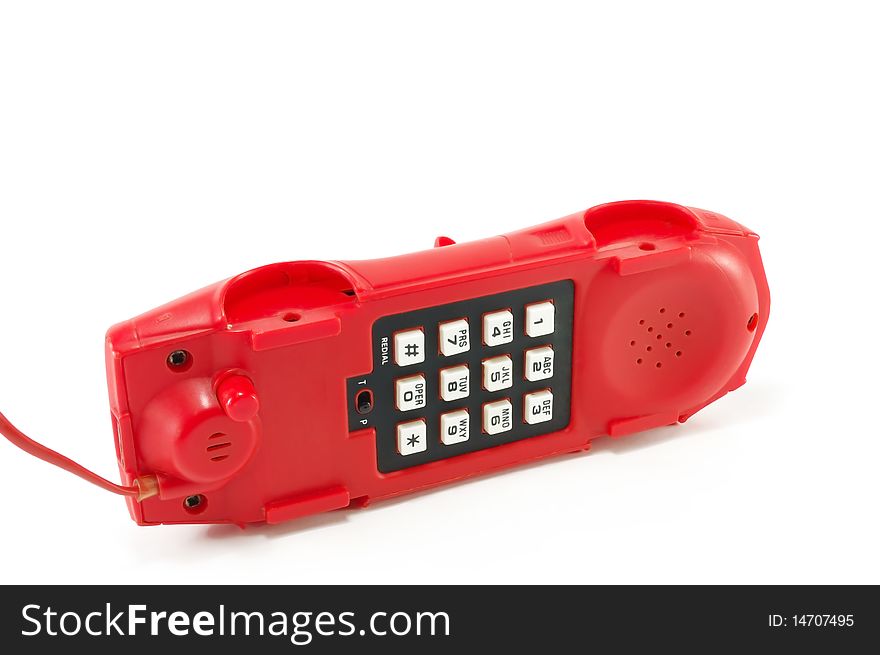 The old red telephone isolated on a white background. The old red telephone isolated on a white background