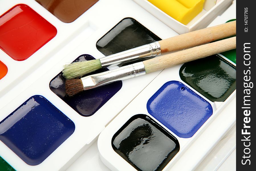 Paints and brushes on a white background