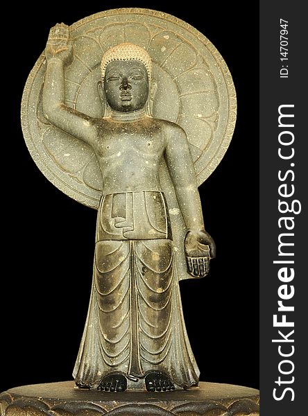 Statue of Buddha carved in stone in the posture of blessing. Statue of Buddha carved in stone in the posture of blessing