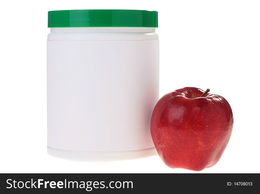 The container with power additives and a red apple.